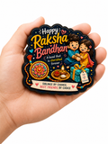 Decorative Fridge Magnet for Raksha Bandhan held in a hand, featuring two children holding hands with text and symbols.